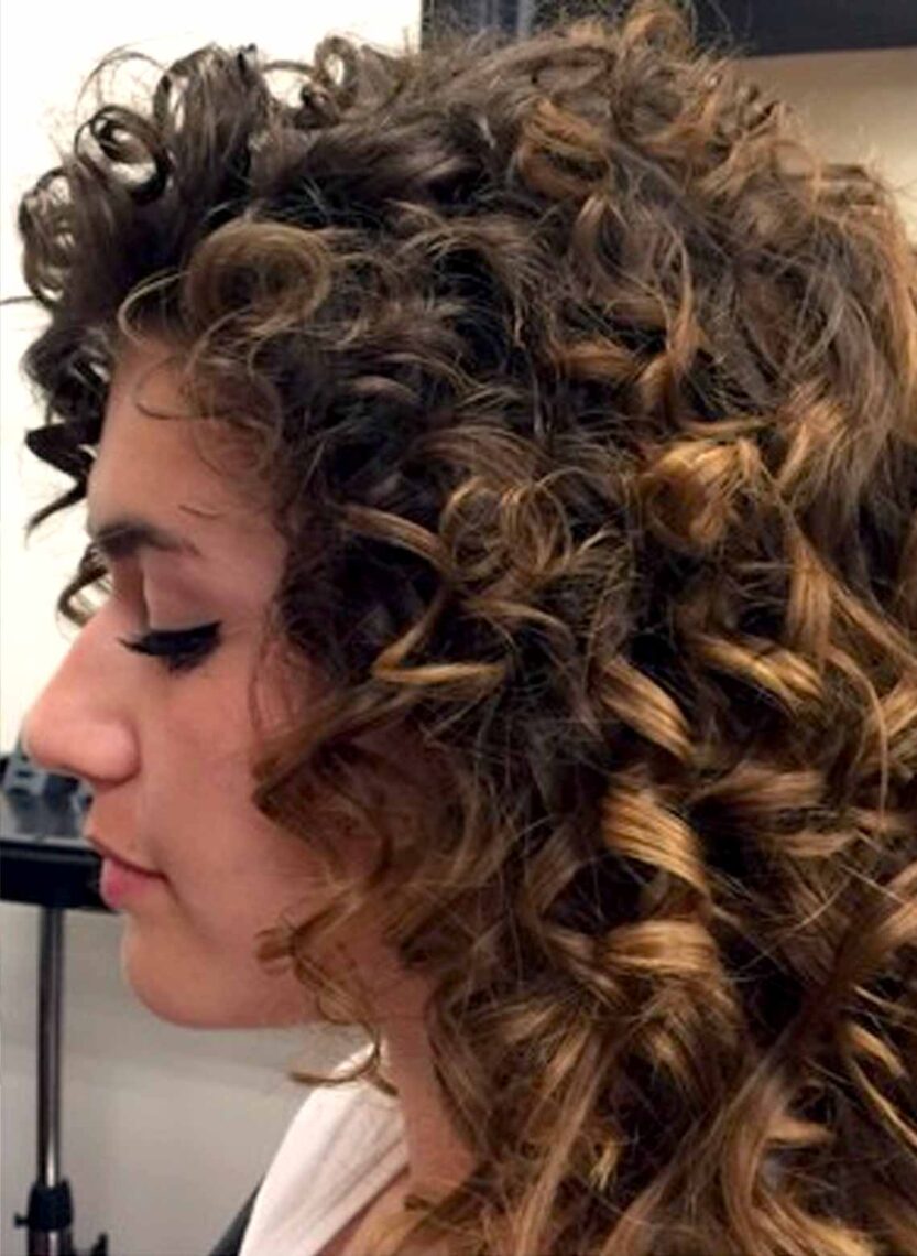 Image shows woman with a Deva cut.