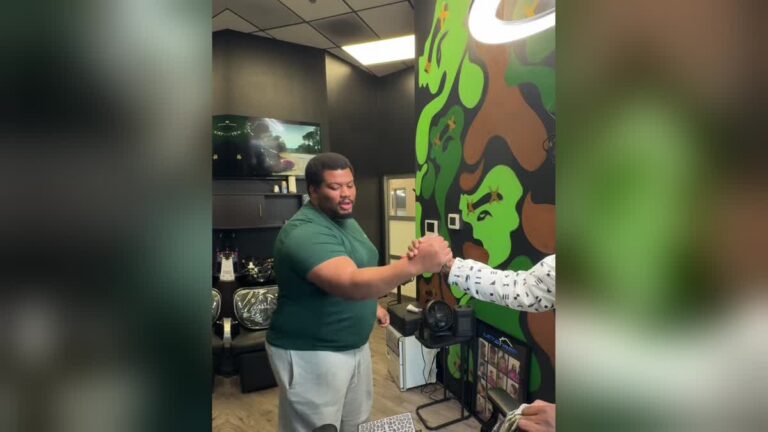 Atlanta barber letstrapcuts greets a client with a handshake at his chair, the first booking of the day on a slow afternoon.
